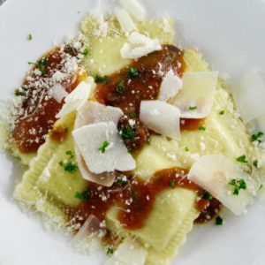 Fresh Ricotta Ravioli with Tomato Sauce, Arugula and Olives